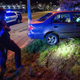 Officer Daniel Arteaga inspects a car crash in Chelsea, Massachusetts on May 1, 2021.